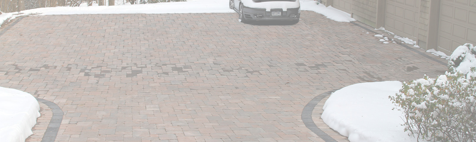 A heated paver driveway after a snowstorm.